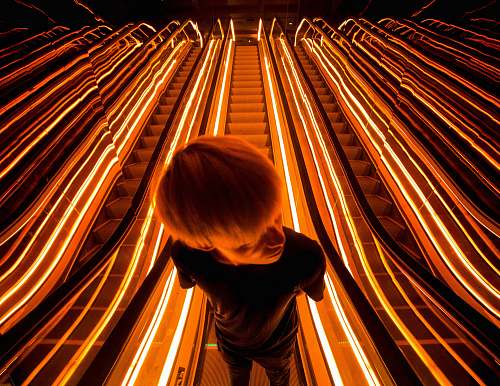 escalator man on escalator with light light